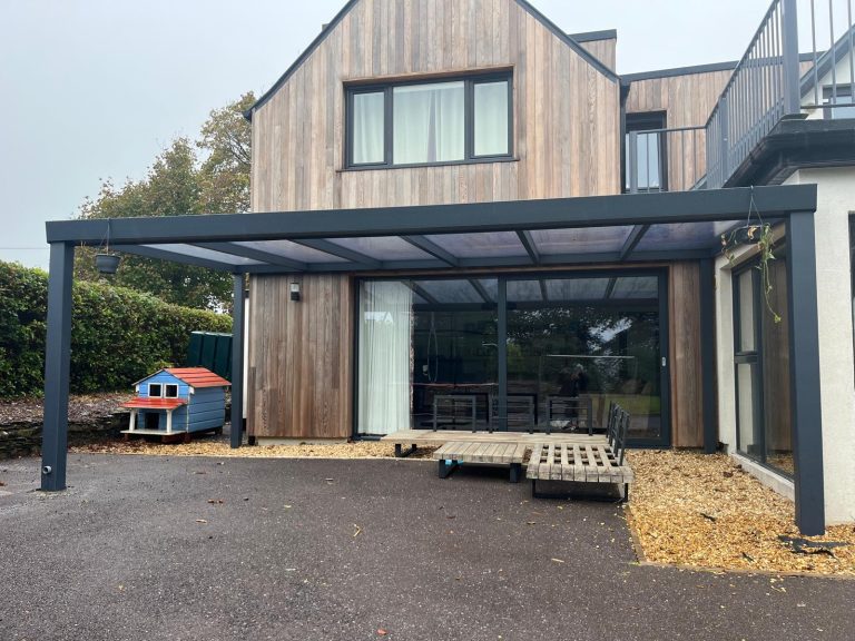 Grey aluminium veranda with polycarbonate roof fitted by Apex Verandas