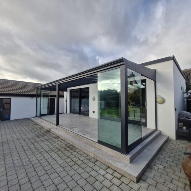 Frameless glass sliding doors on an Apex veranda